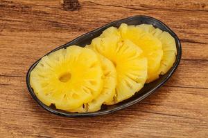 Marinated pineapple rings in the bowl photo