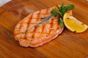 Grilled salmon served lemon and parsley photo