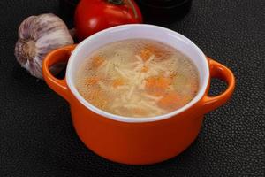 Chicken soup with noodles photo