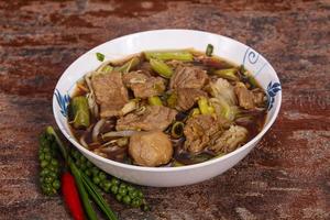 Thai style soup with meat and mushrooms photo