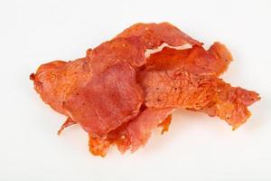 Smoked pork meat over white background photo