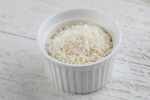 Coconut flakes in bowl photo