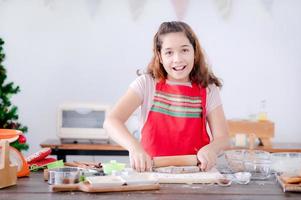 European girls prepare tools and ingredients for making gingerbread during Christmas and New Year celebrations photo