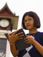 Teen reading clock tower. photo