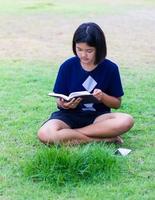 Girl reading on the lawn. photo
