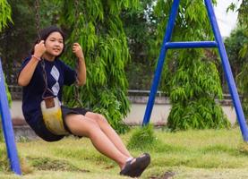 Girl Sitting Swing. photo