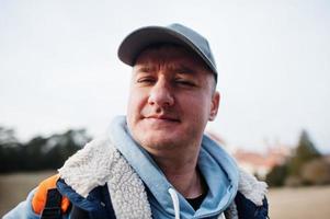 Close up portrait of man in hoodie and cap. photo