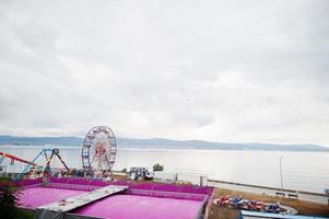 Ferris wheel and attractions on sea beach of Nesebar, Bulgaria. photo