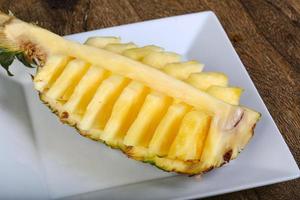 Sliced pineapple on plate photo