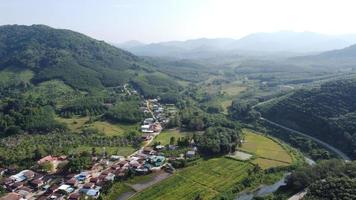 Drone point of view. Songkrom landscape in springtime. Patchwork landscape with single lane winding road photo