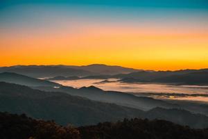 Beautiful foggy winter sunrise in mountains of north Thailand.