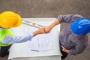 Engineer man and worker team joining hands after meeting at construction site, Success and happiness teamwork concepts photo