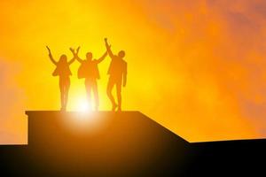Silhouette of Business people team with clipping path at sunset evening sky background, Celebration Success Happiness Teamwork concept. photo