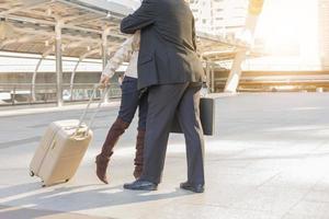 Businessman and businesswoman traveler with luggage at city background, Business People Commuter Walking City Life Concept photo