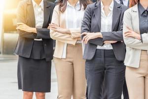 Success Teamwork Concept, Business people standing with arms crossed city background. photo