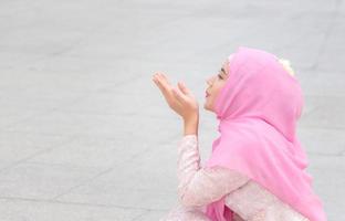 Close up of happiness young Arab Middle Eastern woman sitting on the floor with blurry background photo