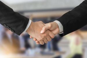 Success and Happiness Team Concept, Business man handshake over blurred business people group meeting background photo