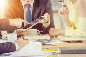 Group of Business Team Meeting Strategy Marketing in a coffee shop chatting to each other while using smartphone tablet laptop internet of things conceptual, Professional investor new startup concept photo