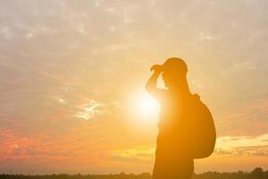 Silhouette of woman with backpack on journey, Weekend Relax Concept. photo