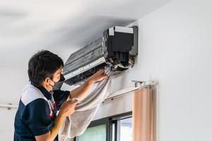 Repairman washing dirty compartments air conditioner, Male technician cleaning air conditioner indoors, Maintenance and repairing concepts photo