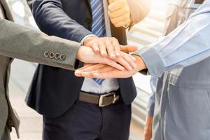 Business people team joined hands and showing thumbs up photo