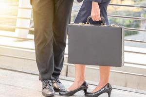 Businessman and businesswoman traveler with luggage at city background, Business People Commuter Walking City Life Concept. photo