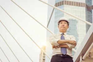 Construction and maintenance Think Big concept, Male architect engineer manager in white helmet with city background photo