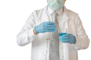 Scientist holding test tubes examining beaker with clipping path on white background photo