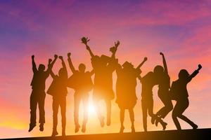 Silhouette of Business People Celebration Success Happiness Team at Sunset Evening Sky Background, with clipping path. photo