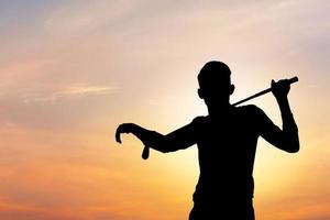 Silhouette of business man with clipping path and golf clubs in hand standing and looking into sky, Success and think big concept. photo
