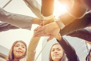 Success Teamwork Concept, Business people team joining hands outside office city background photo