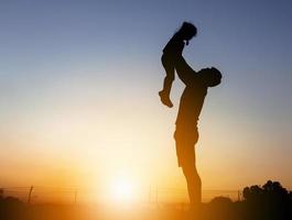 silhouette of a father and a daughter photo