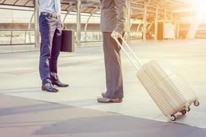 Businessman traveler with luggage at city background photo