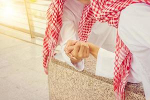 Young Arab Middle Eastern Businessman arm wrestling when friends meeting photo