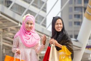 Happy beautiful young Arab business woman with shopping bags ,Happy Shopping in the city concept photo