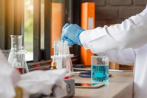 Doctor analyzing medical test tubes examining beaker with fluid, Scientist researching and learning in a laboratory photo