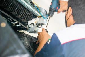 Selective focus on dirty inside compartments air conditioner, Male technician fixing air conditioner indoors, Maintenance and repairing concepts photo