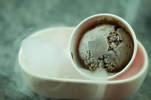 Chocolate flavor ice cream scoops with dry ice smoke photo