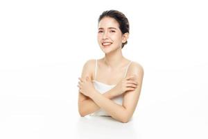 Happy young woman with a beautiful face with perfect clean fresh skin on a white background.