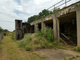 old abandoned cement building with weeds photo