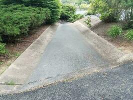 asphalt and cement gutter with drain grate photo