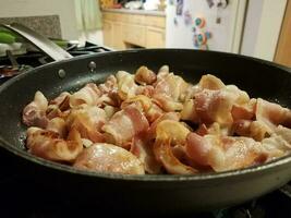 bacon in frying pan or skillet in kitchen photo