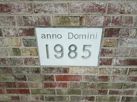 anno domini 1985 sign on brick wall photo