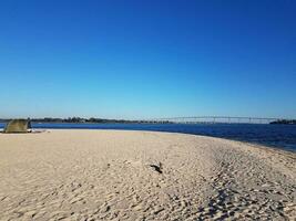 beach and water and bridge at Solomons Island Maryland with tent photo