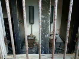 old damaged toilets in abandoned building or ruins photo