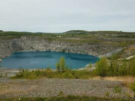 large deep blue lake where asbestos was mined in Canada photo