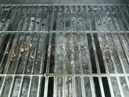 dirty or filthy bars on barbecue grill wih smoke photo
