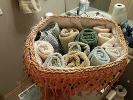 basket of colorful wash cloths or towel in bathroom photo