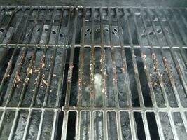 dirty or filthy bars on barbecue grill wih smoke photo