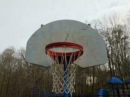 worn or weathered basketball hoop and backboard photo